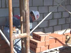 Photo of mason building wall